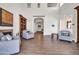 Spacious living room featuring high ceilings, natural light, comfortable seating, and a cozy fireplace at 14575 W Mountain View Blvd # 11315, Surprise, AZ 85374