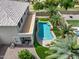 Aerial view of a backyard featuring a beautiful pool, green grass and mature palm trees at 15138 W Campbell Ave, Goodyear, AZ 85395