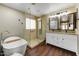 Bathroom featuring a freestanding tub, walk-in shower, vanity, and dual mirrors at 15138 W Campbell Ave, Goodyear, AZ 85395