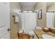 Clean bathroom with shower featuring neutral colors and an organized vanity at 15138 W Campbell Ave, Goodyear, AZ 85395