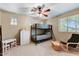 Spacious bedroom with bunk beds, chest of drawers, large window, and comfortable chair at 15138 W Campbell Ave, Goodyear, AZ 85395