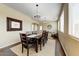 Bright dining room featuring dark wood floors, large windows and an inviting ambiance at 15138 W Campbell Ave, Goodyear, AZ 85395