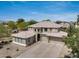 A spacious house with a well-manicured lawn, three-car garage, and a tile roof exudes sophistication at 15138 W Campbell Ave, Goodyear, AZ 85395