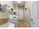 Laundry room with a washer, dryer, shelving, storage basket, and tile flooring at 15138 W Campbell Ave, Goodyear, AZ 85395