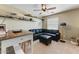 Cozy living area complete with comfortable seating, floating shelves, and overhead fan at 15138 W Campbell Ave, Goodyear, AZ 85395