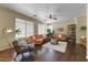 Sun-filled living room with a ceiling fan, multiple sofas, and a decorative rug at 15138 W Campbell Ave, Goodyear, AZ 85395