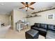 Cozy living area complete with comfortable seating, floating shelves, and overhead fan at 15138 W Campbell Ave, Goodyear, AZ 85395