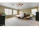 Large main bedroom with ample natural light, carpet flooring, ceiling fan, and neutral paint at 15138 W Campbell Ave, Goodyear, AZ 85395