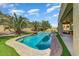 Inviting backyard oasis with a sparkling pool, lush landscaping, and covered patio at 15138 W Campbell Ave, Goodyear, AZ 85395