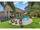 A sparkling pool surrounded by lush, green grass creates a backyard oasis, perfect for relaxation and enjoyment at 15138 W Campbell Ave, Goodyear, AZ 85395