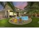 A sparkling pool surrounded by lush, green grass creates a backyard oasis, perfect for relaxation and enjoyment at 15138 W Campbell Ave, Goodyear, AZ 85395