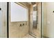 This walk-in shower features a rainfall shower head, handheld sprayer, and sleek design at 15138 W Campbell Ave, Goodyear, AZ 85395
