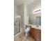 Bright bathroom featuring a glass enclosed shower with bench and modern fixtures at 16158 W Christy Dr, Surprise, AZ 85379
