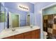 Bright bathroom with dual sink vanity, large mirror, and tub/shower combination at 16158 W Christy Dr, Surprise, AZ 85379