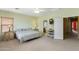 Airy bedroom featuring a ceiling fan and doorway to an ensuite bathroom at 16158 W Christy Dr, Surprise, AZ 85379