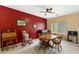 Inviting dining room features red accent wall, natural light, and cozy furnishings for relaxed dining at 16158 W Christy Dr, Surprise, AZ 85379
