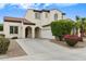 Beautiful home featuring an arched entryway, a well-manicured lawn, and an attached two-car garage at 16158 W Christy Dr, Surprise, AZ 85379