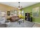 The living room provides a relaxed atmosphere with bright green accent wall, plush seating, and decorative shelves at 16158 W Christy Dr, Surprise, AZ 85379
