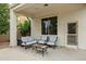 Relaxing covered patio with comfortable seating, ideal for outdoor living and entertaining with overhead lighting at 16158 W Christy Dr, Surprise, AZ 85379