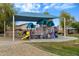 Community playground with slides, climbing structures, and covered seating for fun and safe play at 16158 W Christy Dr, Surprise, AZ 85379