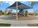 Community playground with slides, swings, and shaded area, perfect for outdoor activities at 16158 W Christy Dr, Surprise, AZ 85379