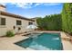 Backyard oasis featuring a private pool with a beautiful water feature and lush landscaping at 16158 W Christy Dr, Surprise, AZ 85379