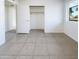 Light bedroom with neutral tile and closet with rods and shelves at 17405 N 19Th Dr, Phoenix, AZ 85023