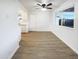 Bright dining room area with hardwood floors, ceiling fan, and a large window at 17405 N 19Th Dr, Phoenix, AZ 85023