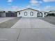 Charming single-story home featuring a white brick facade and a well-maintained concrete driveway at 17405 N 19Th Dr, Phoenix, AZ 85023