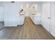 Clean white kitchen with modern cabinets, appliances, and hardwood flooring at 17405 N 19Th Dr, Phoenix, AZ 85023