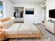 Well-lit bedroom featuring a comfortable bed, closet, dresser, and a mounted TV for added convenience at 17405 N 19Th Dr, Phoenix, AZ 85023