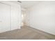 Bedroom with carpet flooring, closet, and bright natural light at 17433 W Eva St, Waddell, AZ 85355
