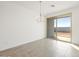 Dining room with tile floors, a chandelier, and a sliding glass door at 17433 W Eva St, Waddell, AZ 85355