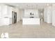 Modern kitchen with white cabinets, stainless steel appliances, and center island at 17433 W Eva St, Waddell, AZ 85355