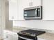 Modern kitchen with granite countertops, stainless steel appliances, and stylish pendant lighting at 17433 W Eva St, Waddell, AZ 85355