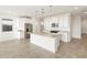 Well-lit kitchen featuring a center island with granite countertops and pendant lighting at 17433 W Eva St, Waddell, AZ 85355