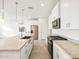 Modern kitchen with granite countertops, stainless steel appliances, and stylish pendant lighting at 17433 W Eva St, Waddell, AZ 85355