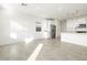Bright living room with tile floors and white kitchen appliances at 17433 W Eva St, Waddell, AZ 85355