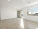 Bright living room with tile floors, recessed lighting, and a sliding glass door at 17433 W Eva St, Waddell, AZ 85355