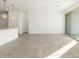 Open-concept living room with sliding glass doors to a patio and tile floors at 17433 W Eva St, Waddell, AZ 85355