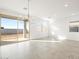 Spacious living room with tile flooring and sliding glass doors that provide outdoor access at 17433 W Eva St, Waddell, AZ 85355