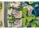 Aerial view of a home near a lake featuring a pool, a well-manicured lawn, and mature trees at 175 N Brookside St, Chandler, AZ 85225
