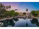 Aerial twilight view of a home overlooking a serene lake with palm trees at 175 N Brookside St, Chandler, AZ 85225