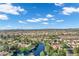 An expansive aerial view of a well-planned neighborhood, including a water feature, mature landscaping and vegetation at 175 N Brookside St, Chandler, AZ 85225
