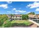 View of the backyard featuring a large manicured lawn and covered patio looking out at the blue sky at 175 N Brookside St, Chandler, AZ 85225