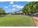 Expansive backyard features lush green lawn, mature trees, and a covered patio, perfect for entertaining at 175 N Brookside St, Chandler, AZ 85225
