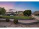 Spacious two-story home featuring a lush lawn and landscaped backyard at twilight at 175 N Brookside St, Chandler, AZ 85225