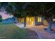 Spacious backyard featuring a covered patio, lush grass, and a large mature tree at 175 N Brookside St, Chandler, AZ 85225