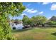 Serene backyard view featuring lush greenery, mature trees, and tranquil lake, perfect for outdoor enjoyment at 175 N Brookside St, Chandler, AZ 85225