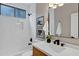 Bright bathroom featuring a shower-over-tub, white subway tiles, and modern vanity with stylish mirror at 175 N Brookside St, Chandler, AZ 85225